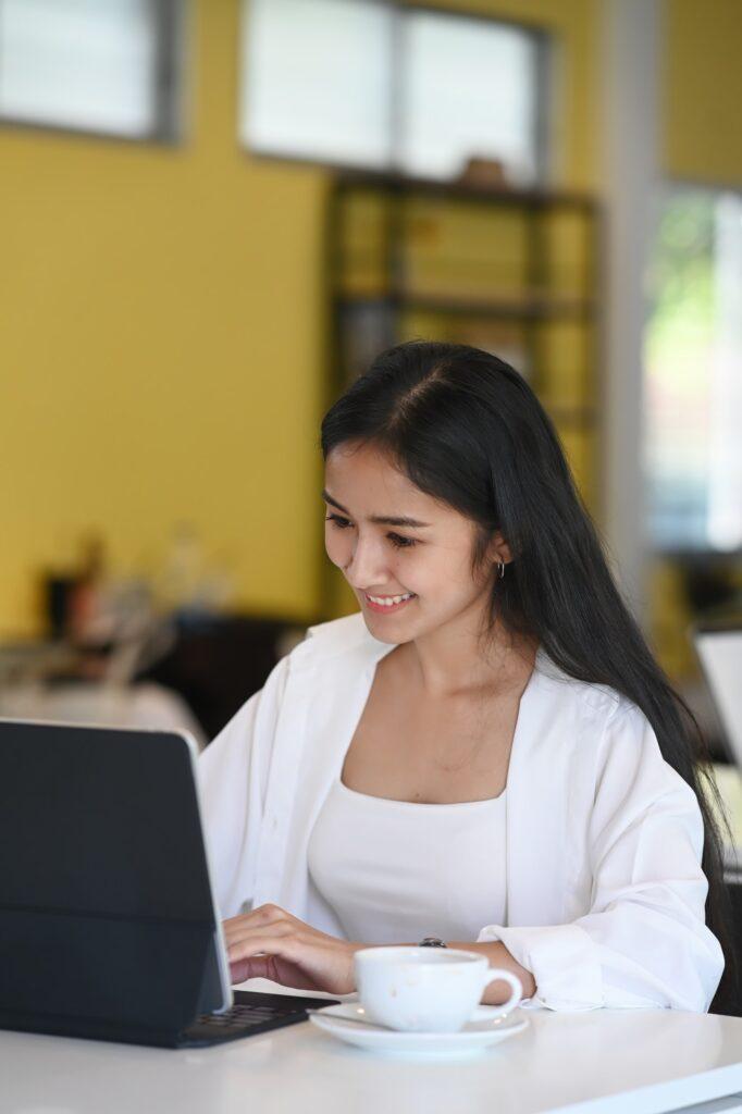 Happy young woman using computer tablet and reading good news in email.